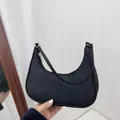 Minimalist black crescent hobo shoulder bag with matte texture and silver zipper detail - Black