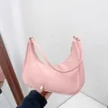 Pink nylon crescent shoulder bag featuring a minimalist half-moon design for women - Pink