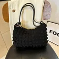 Chic black pleated underarm bag featuring bubble textured fabric and gold hardware - Black