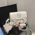 White PU leather satchel with blue cartoon embroidery and adjustable shoulder strap - White