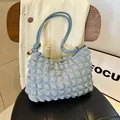 Light blue ruched shoulder bag with textured bubble fabric and gold hardware details - Blue
