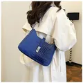 Detail of dark blue crocodile embossed shoulder bag with silver rectangular twist lock - Blue