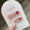 Sparkly raspberry red press-on nails with heart rhinestones and glitter in coffin shape - Large (L)