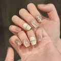 Short press-on nails in champagne cat-eye design with sequins and 3D silver lines - XS / Extra Short Coffin (725)