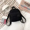 Mini corduroy backpack in solid black with vertical texture and front pocket - Black