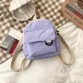 Mini lavender corduroy backpack with front pocket and cream colored woven straps - Purple