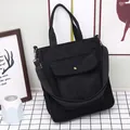 Minimalist black corduroy tote bag with front pocket and adjustable shoulder strap - Black