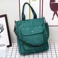Dark green corduroy tote bag with front button pocket and adjustable shoulder strap - Green