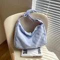 Light blue waffle textured hobo bag with adjustable strap on a chair - No Pendant / Blue