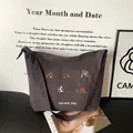 Brown corduroy tote bag with floral embroidery and Harvest Day text on wide shoulder strap - Gray