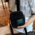 Vintage black corduroy crossbody bag for women with adjustable strap and green logo label - Black