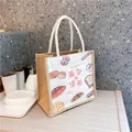 Détail du sac en jute avec illustration de pain et poignées en coton doux - Pain
