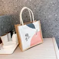Minimalist burlap tote bag with ORANGE print and sturdy white braided cotton rope handles - Orange