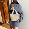 Straw bucket handbag with cream woven texture and white canvas handles for summer - Off White