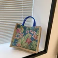 Florale Canvas-Tragetasche mit tropischem Blattmuster und blauen Henkeln für Alltag - Blau