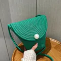 Chic emerald green woven crossbody bag featuring a large pearl button closure - Large Pearl Style (0857) / Green