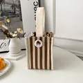 Mini canvas handbag with brown and white stripes featuring a cute cartoon badge decoration - Brown