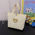 Mini off-white corduroy handbag with cute bear embroidery and metal button snap closure - White