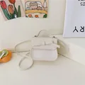 Chic beige crossbody girl's bag with bow decoration and stylish top handle design - White