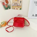 Mini red crossbody bag for girls with cute bow accent and white contrast stitching detail - Red