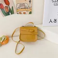 Chic mustard yellow girl's mini crossbody bag with cute bow and white stitching detail - Yellow