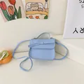 Light blue mini crossbody bag for girls with bow decoration and white stitching details - Blue