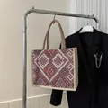 Ethnic style woven linen tote bag featuring geometric patterns and brown handles - Red