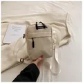 Corduroy crossbody phone bag in beige with adjustable strap and woven brand label - Off White