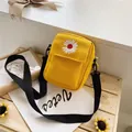 Yellow canvas crossbody bag with daisy embroidery and adjustable black strap - Yellow