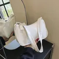 Minimalist white faux leather shoulder bag with sleek finish and mirror reflection shot - White