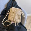 Beige faux suede crossbody bag with fringe tassels and woven rope shoulder strap - White
