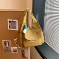Yellow canvas tote bag with front pocket and a cute plush keychain charm accessory - With Pendant / Brown