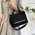 Black corduroy shoulder bag with front stripe pocket and adjustable crossbody strap - Black