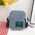 Mini light blue corduroy crossbody bag with green strap and woven label detail - Gray