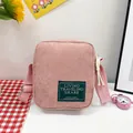 Pink corduroy crossbody phone bag with adjustable strap and green woven label - Pink