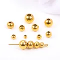 Detailed macro shot of various sized golden stainless steel spacer beads for jewelry making - Width 2mm Hole 1mm / 18K Gold