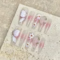 Close-up of pink gradient press-on nails with 3D floral and butterfly ornaments - XS / 1946 Extra Long Coffin