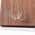 Dettaglio di chiodini a T in argento in tre lunghezze per la creazione di gioielli - 0.6x35mm / Colore acciaio
