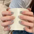 Detail of luxury press-on nails featuring silver glitter gradient and rhinestones - 1 Long Coffin (1)