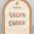 Detail of handmade short press-on nails with shiny glitter, pearls, and colorful rhinestones - XS / Nude Pink (1552 Short Coffin)