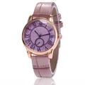 Detail of rose gold watch case with Roman numeral dial and pink crocodile leather strap - Lavender