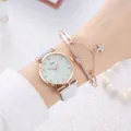 Close-up of elegant Tadi watch with white leather strap and matching star charm bracelet - Light Blue + Bracelet