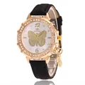 Detailed macro view of gold butterfly pattern dial with crystals and black strap - Black Watch Only