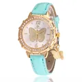 Detailed close-up of a ladies' quartz watch with gold butterfly dial and crystal bezel - Cyan Single Watch