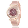 Detail of rose gold mesh watch with roman numerals and moving crystals on burgundy dial - Red