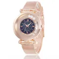 Close-up of rose gold watch with blue starry sky dial and sliding crystals on the bezel - Blue