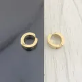 Detailed view of golden stainless steel clip-on earrings with brushed metal texture finish - Gold