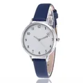 Detail view of quartz watch with white dial, silver case, and navy blue leather strap - Blue