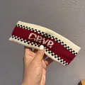 Close-up of cream knit headband with red golf stripe and checkered texture details - Wine Red And Beige