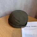 Detail of army green nylon skullcap with RIDER embroidery on light wood surface - Adjustable / Army Green